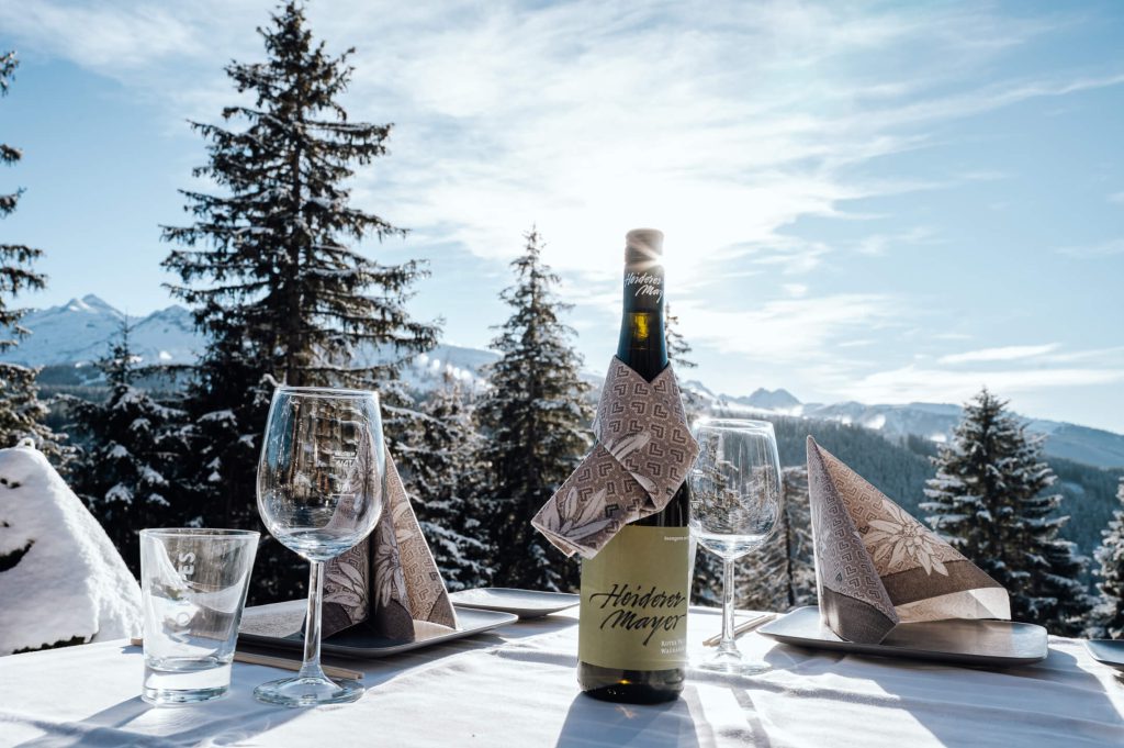 Romantic Table with Wine and Glasses, Surrounded by Snow-Covered Mountains in the Zillertal.